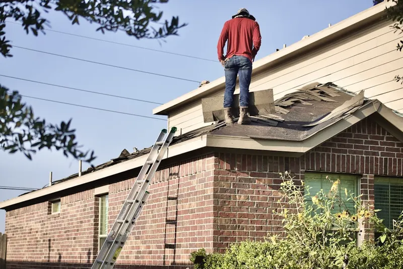 Professional roofer working on a residential roof in Brewster